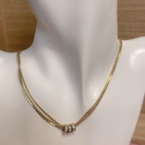 Gorgeously stunning layered gold necklace with 3 ring accents surrounded in gems